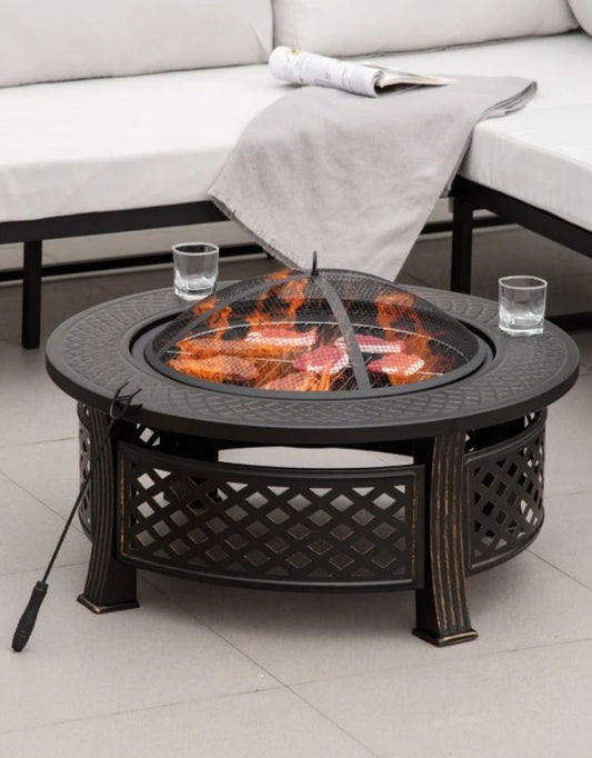 Outdoor fire pit table with flames burning, used as a patio BBQ grill.