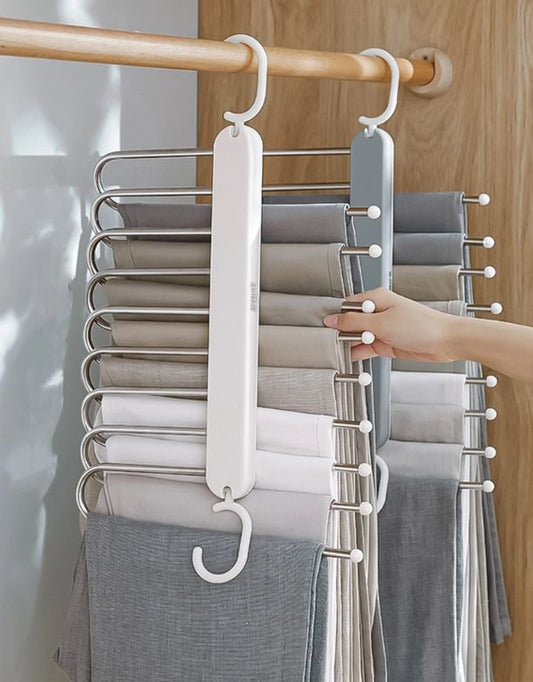 Multi-layer pants hanger with clothes neatly organized in a closet.