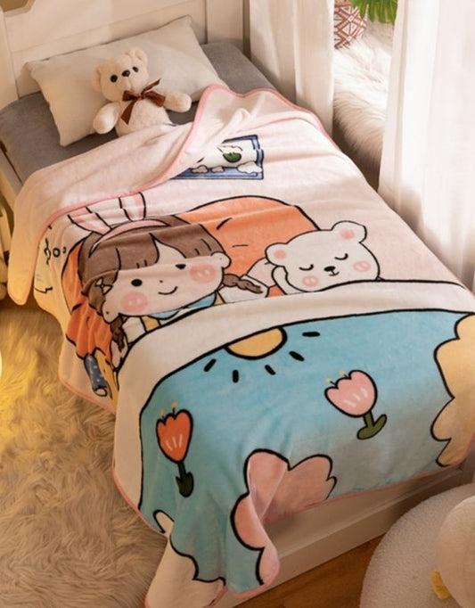 Children's blanket with a flannel fabric, featuring cartoonish characters and a kitty design, draped over a bed with a teddy bear on top.