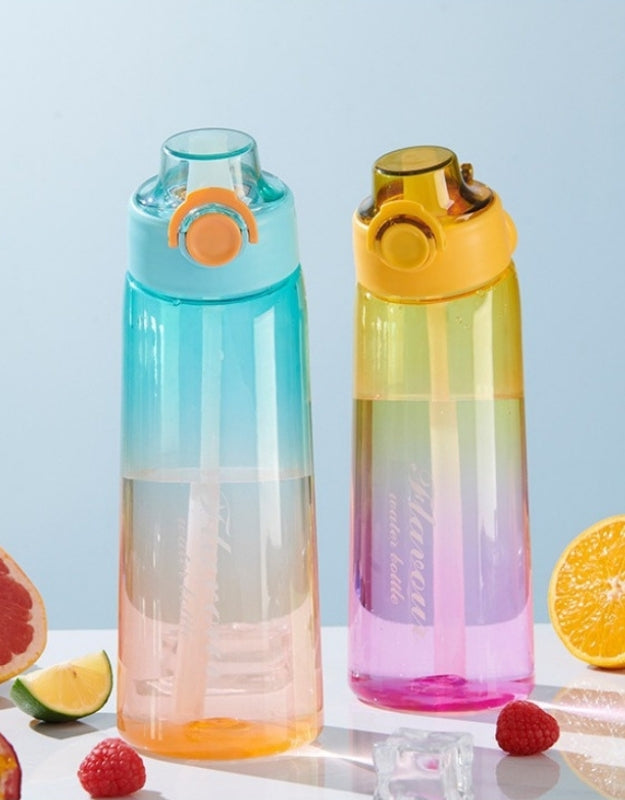 Two gradient Tritan water bottles on table surrounded by fruits and ice cubes