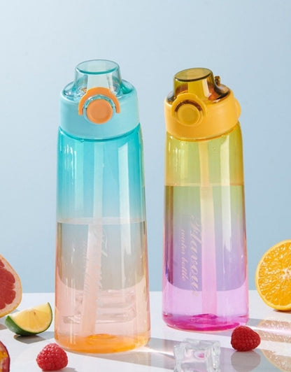 Two gradient Tritan water bottles on table surrounded by fruits and ice cubes