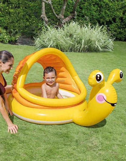 Child playing inside the Intex 57124NP Lazy Snail Shade Baby Pool outdoors with parent nearby.