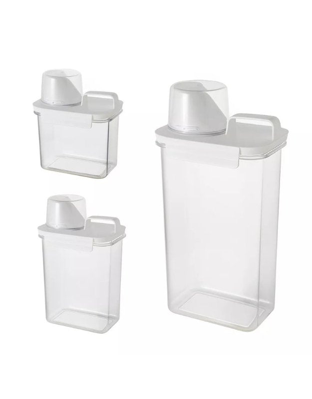 Set of clear plastic storage containers with white lids on a white background. Set of three clear airtight storage containers with measuring cup in different sizes.