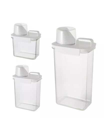Set of clear plastic storage containers with white lids on a white background. Set of three clear airtight storage containers with measuring cup in different sizes.
