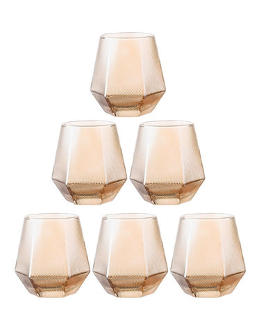 Set of six peach-colored tumblers with geometric designs on a white 
background. Set of six amber faceted drinking glasses with textured design on white background.