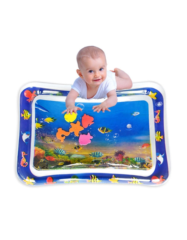 A baby in a diaper lying on their stomach on the water play mat, simulating the action of swimming, used for active tummy time.