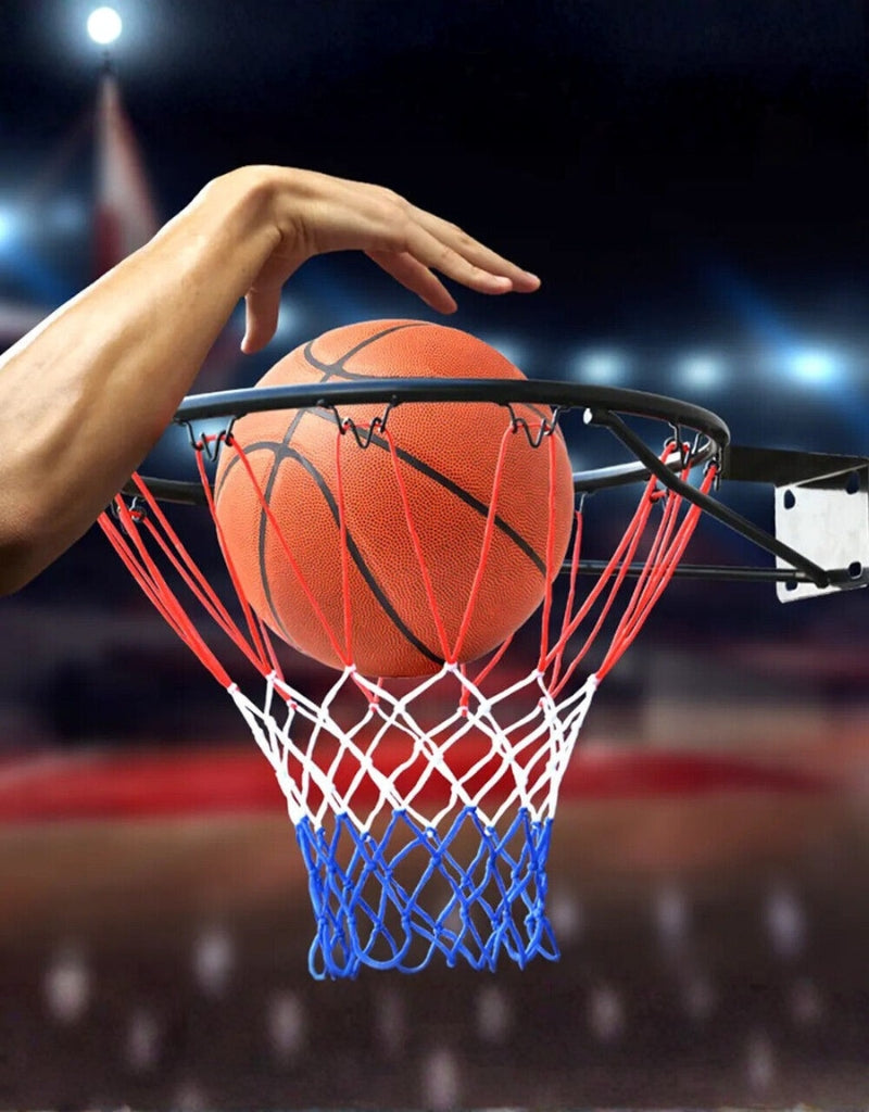 Basketball dunk going through red, white, and blue hoop net on court