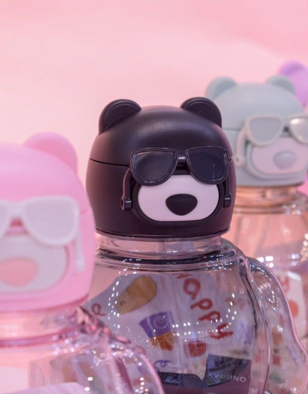 Close-up of bear bottle caps with sunglasses in pink, black, mint, and purple colors, 850ml.