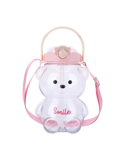 Clear bear-shaped water bottle with pink lid and pink shoulder strap. The word "Smile" is written in pink on the front.