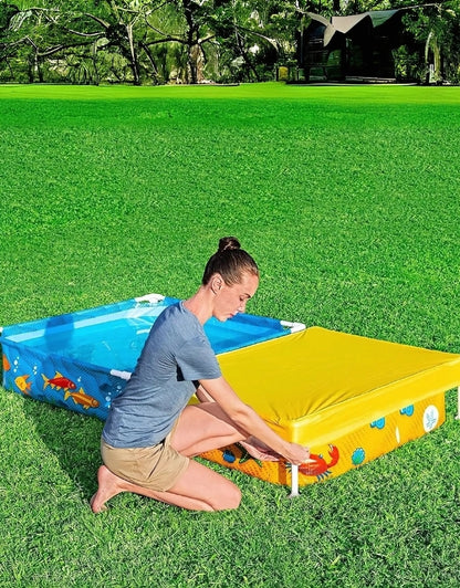 Adult closing the yellow sandpit section cover of Bestway 561CF frame pool and sandpit set
