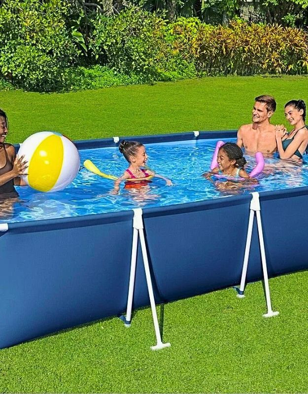 Family enjoying the Bestway 56405 Steel Pro rectangular frame pool while playing with a beach ball.