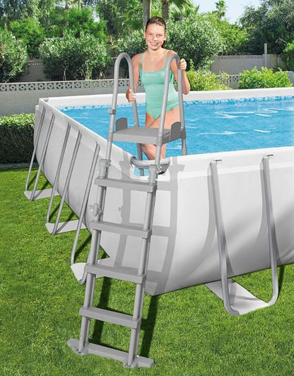 Woman climbing the ladder into the Bestway 564752 Power Steel rectangular above ground swimming pool
