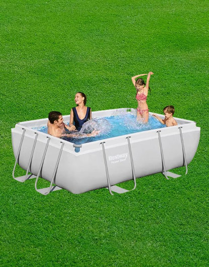 Family enjoying the Bestway 56629 Power Steel rectangular above ground swimming pool in the garden.