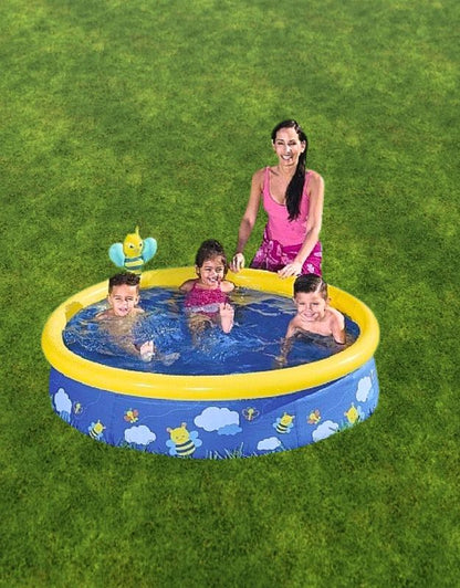 Children playing with their mother inside the Bestway 57326 Fast Set Spray Pool on the grass