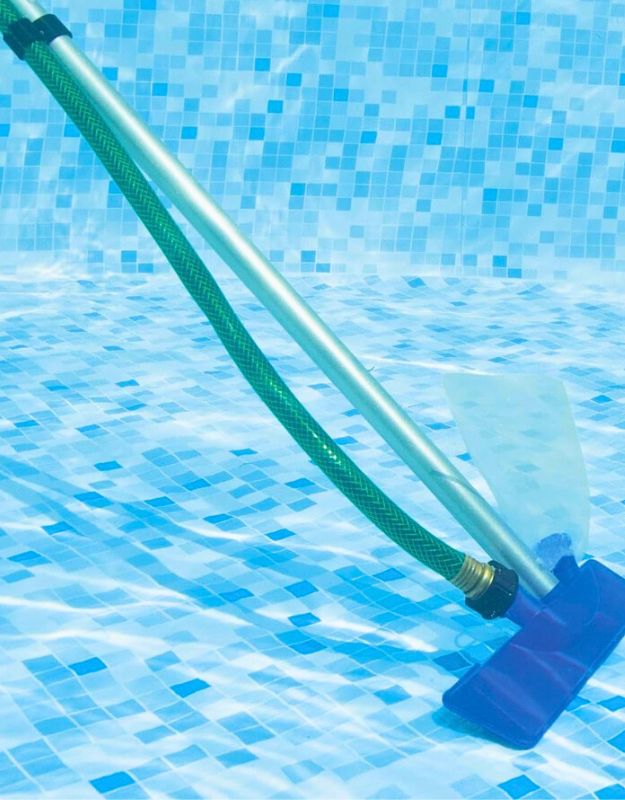 Bestway 58013 pool vacuum head with green hose cleaning debris from pool floor