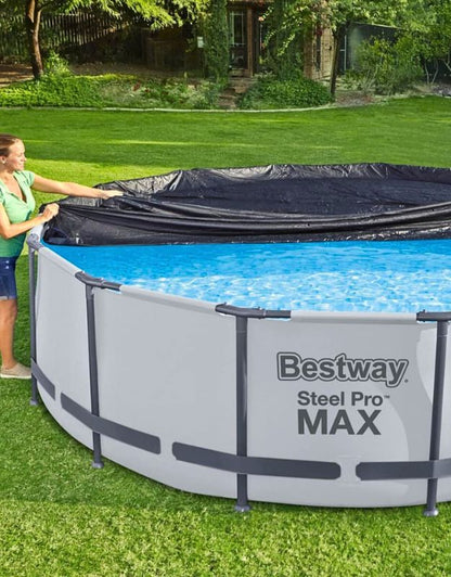 Woman placing Bestway Flowclear 370 cm black pool cover on a filled Steel Pro Max round pool