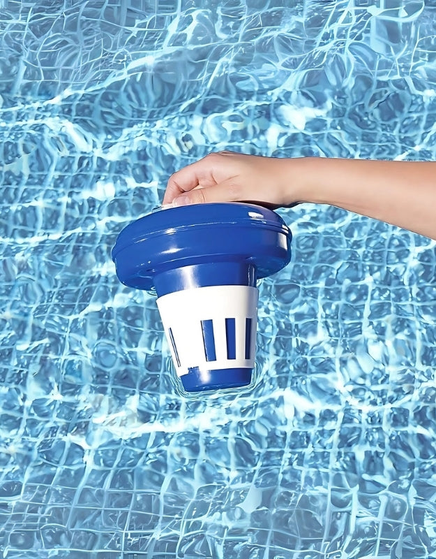 Hand holding Bestway 58071 floating chlorine dispenser above swimming pool water