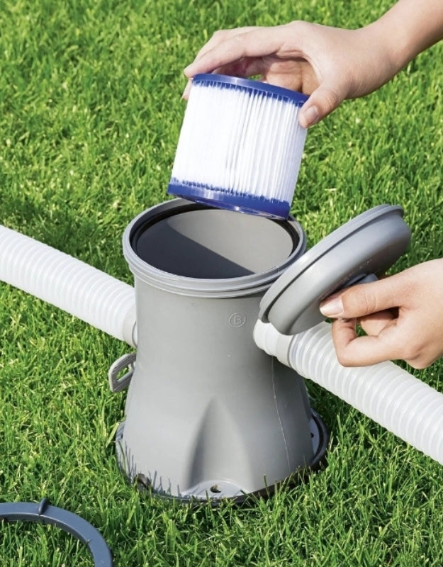 Hand replacing Bestway 58093 Hepa Filter Size 1 in pool pump system on grass