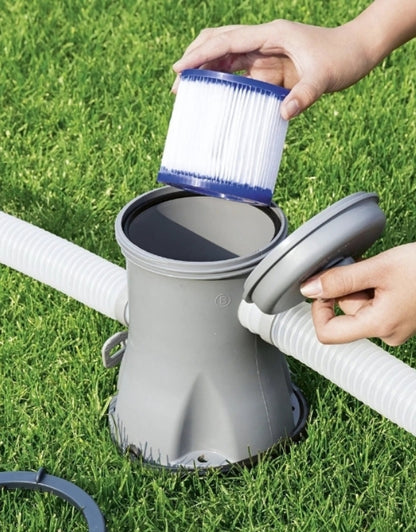 Hand replacing Bestway 58093 Hepa Filter Size 1 in pool pump system on grass