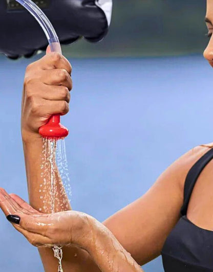 Close-up of red shower nozzle with water flow from the Bestway 58224 solar-heated shower.
