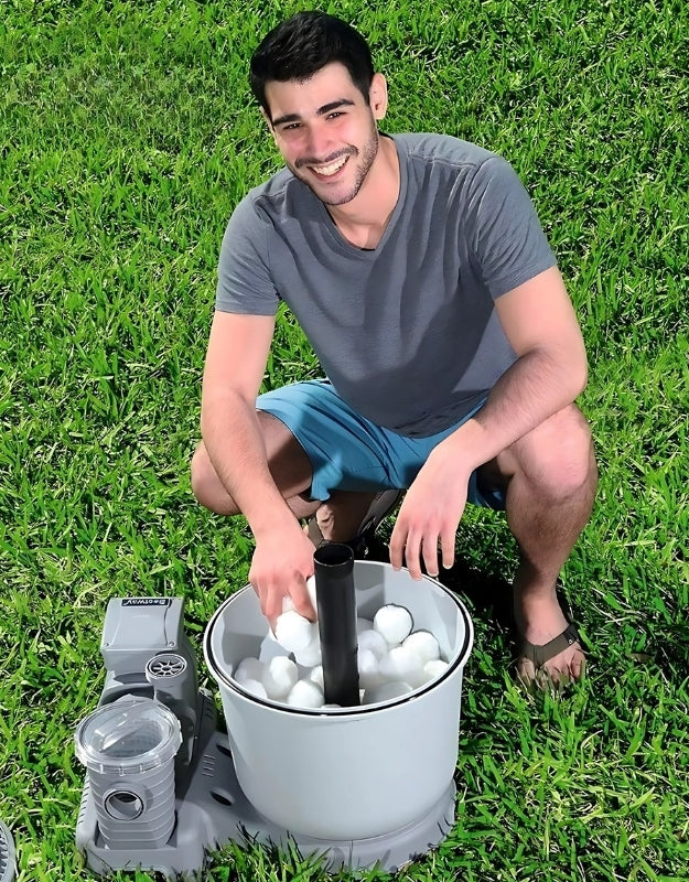 Man using Bestway Flowclear Polysphere 500g filter balls in sand filter system outdoors