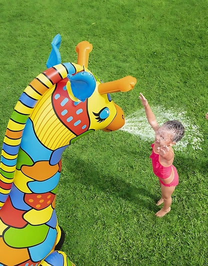 A kid playing with the Bestway Jumbo Giraffe inflatable sprinkler in a yard.

