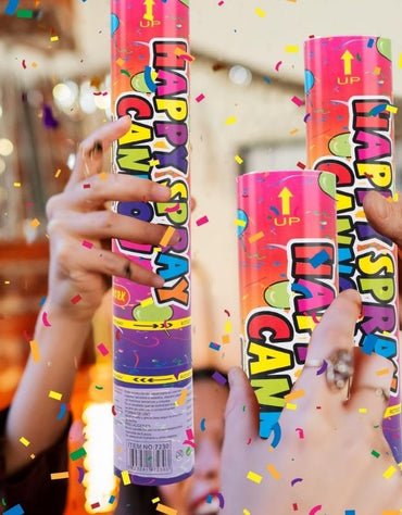 People holding colorful confetti cannons with confetti flying during celebration.