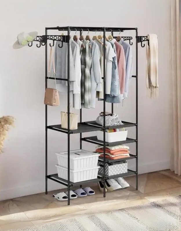A freestanding metal garment rack with multiple hanging rails and storage shelves, displaying various clothing items and storage boxes.