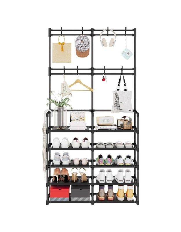 Front view of black metal shoe rack with coat hooks, holding shoes, bags, and accessories.