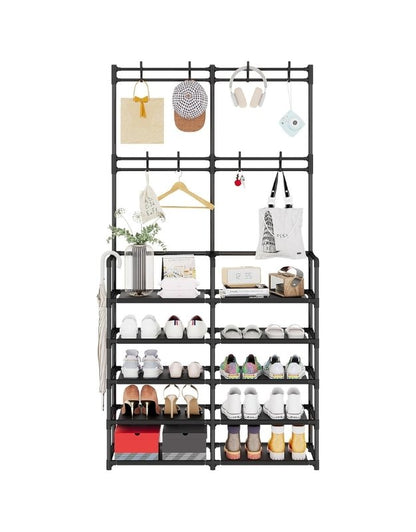 Front view of black metal shoe rack with coat hooks, holding shoes, bags, and accessories.