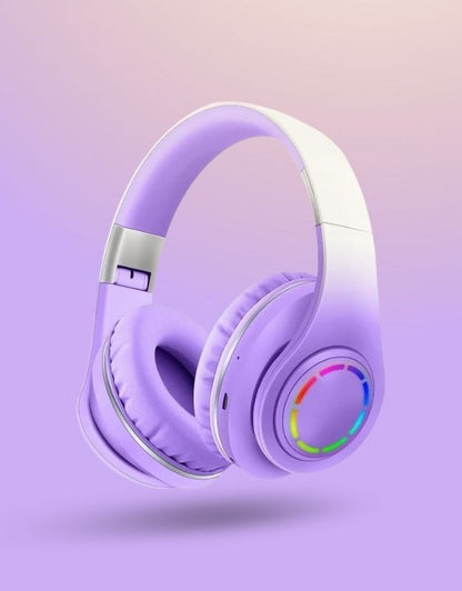 A pair of purple wireless headphones with multicolored LED lights on the ear cups.