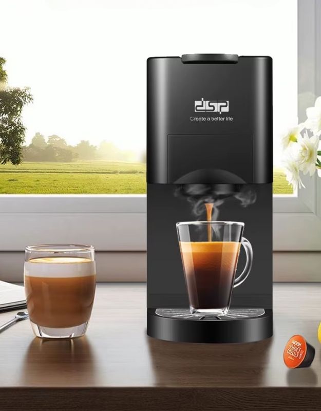 Black capsule coffee machine brewing hot espresso into a glass cup.