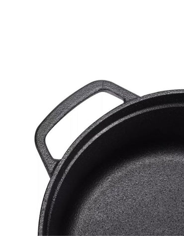 Close-up of a black cast iron skillet on a white background. Close-up of a durable handle on a black cast iron cooking pot.