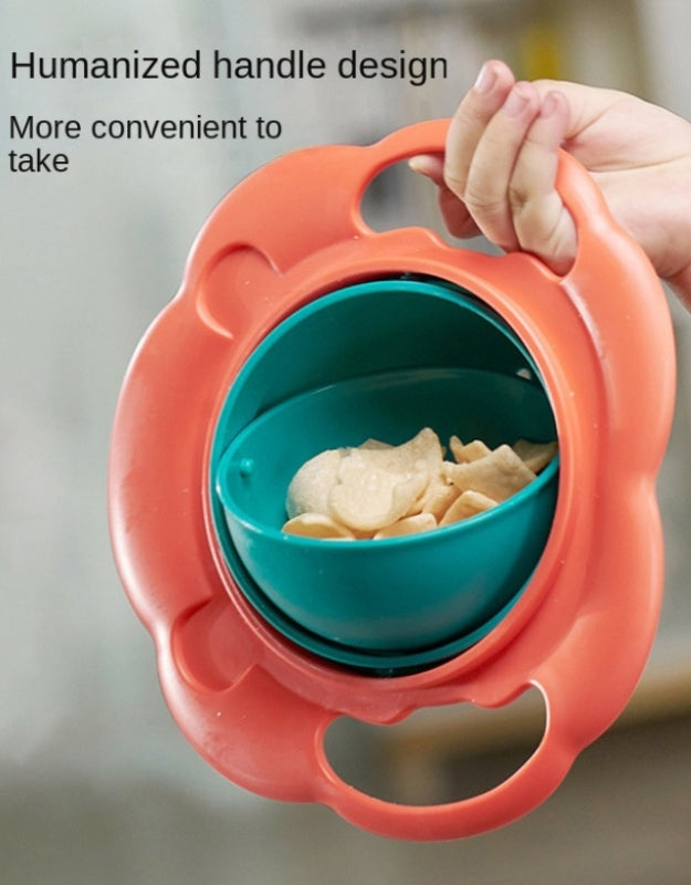 Toddler holding the spill-proof snack bowl vertically without spilling the contents.