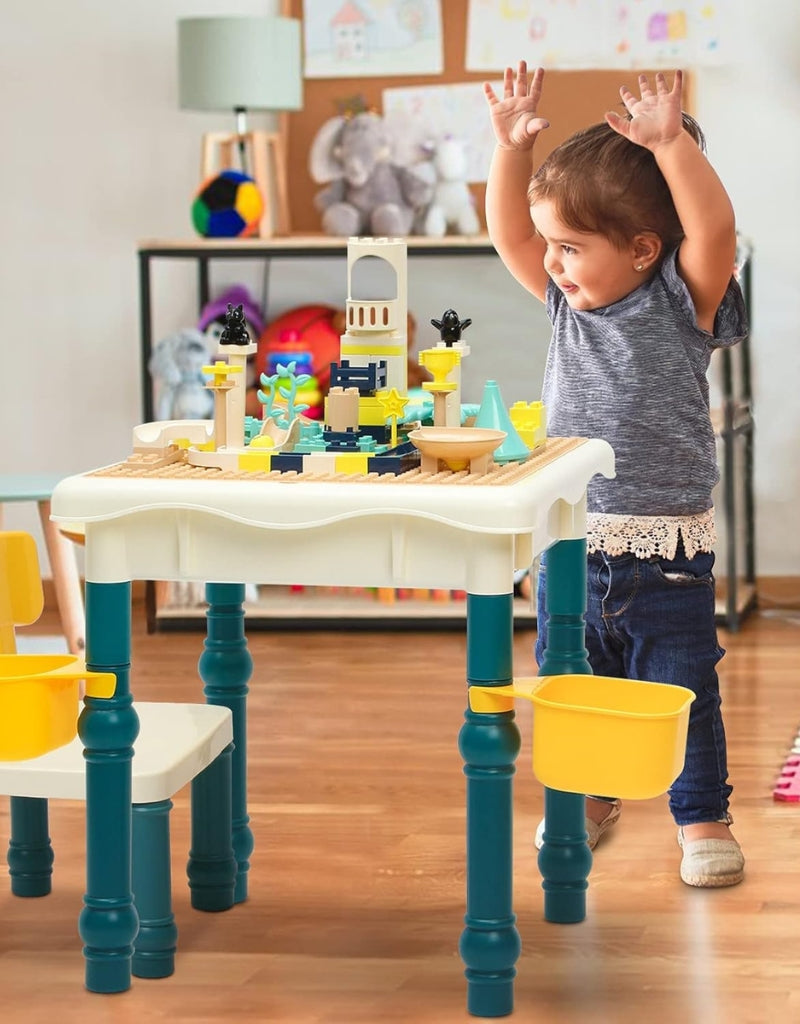 Toddler happily playing with the construction table set and building blocks.