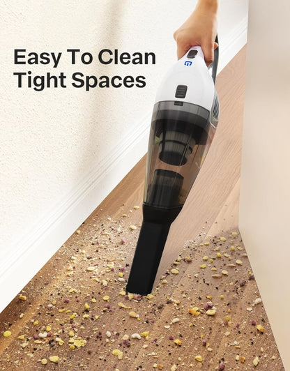 Cordless vacuum cleaner with nozzle attachment cleaning tight floor spaces.