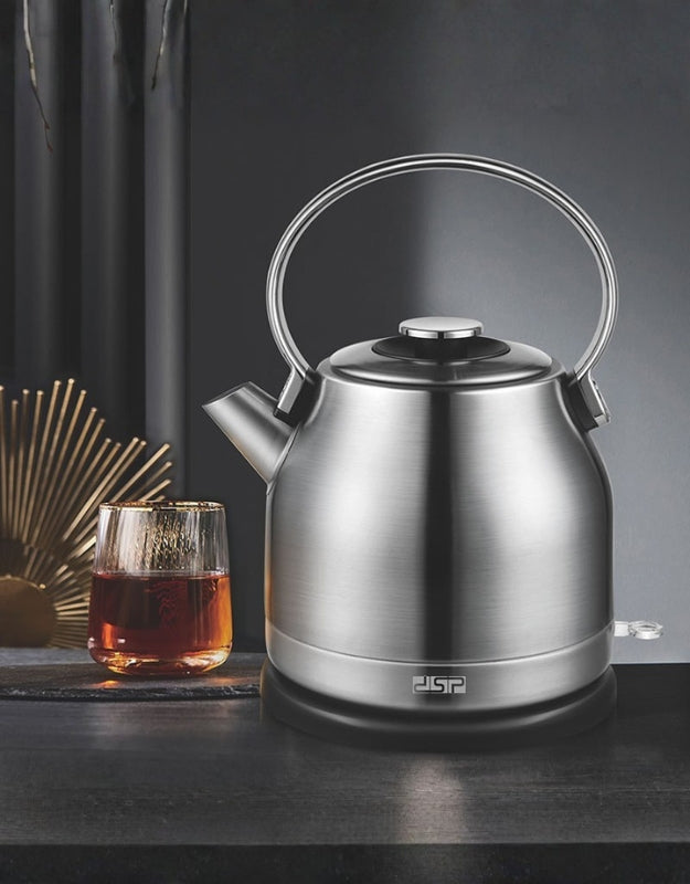 DSP 1.7L electric stainless steel kettle displayed on a modern kitchen counter beside a glass of tea