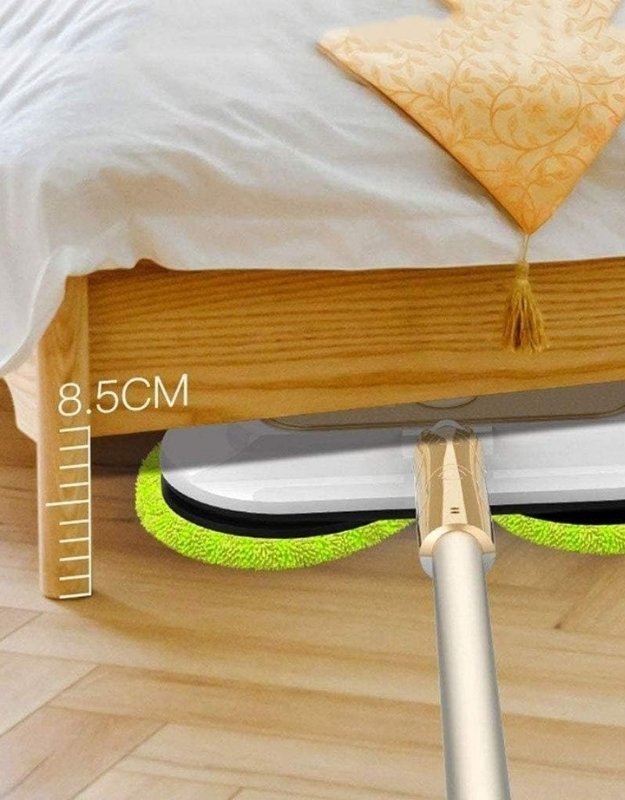 Cordless electric spin mop cleaning under low furniture with 8.5cm clearance.