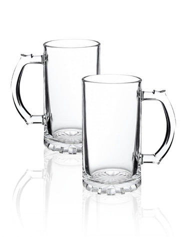Two clear glass mugs with handles on a white background. Set of two empty clear glass beer mugs with handles on white background.