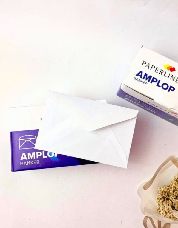 Small white envelope placed on top of a blue Paperline Amplo Banker box, with some dried flowers visible on the side.