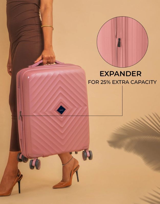 Expandable rose pink suitcase with 25% extra capacity shown open.