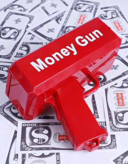 Red Money Gun placed on scattered fake money bills.