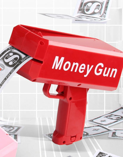 Close-up of red Money Gun labeled “Money Gun” dispensing fake cash.
