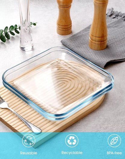 Empty square tempered glass plate on a wooden board with icons showing reusable, recyclable, and BPA-free.