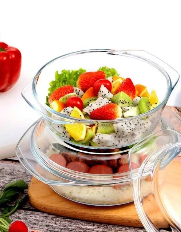 Tempered glass casserole bowl filled with fresh fruit salad and vegetables.