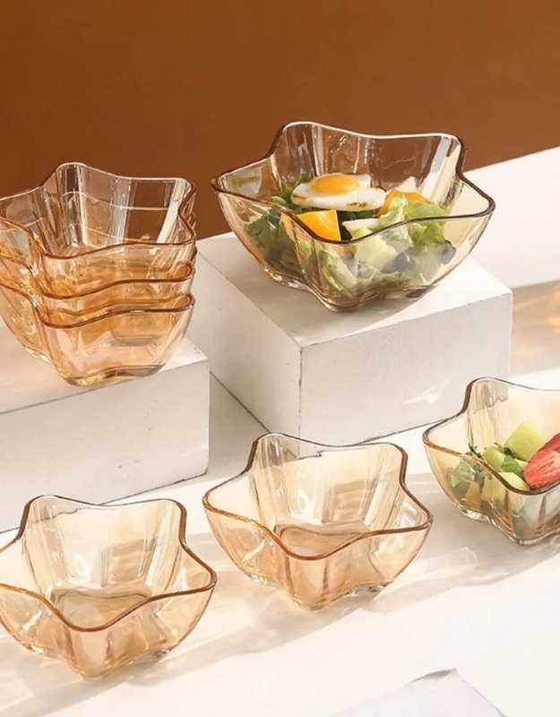 Stacked and individual amber star-shaped glass bowls used for salad and desserts from the 7 pcs set.