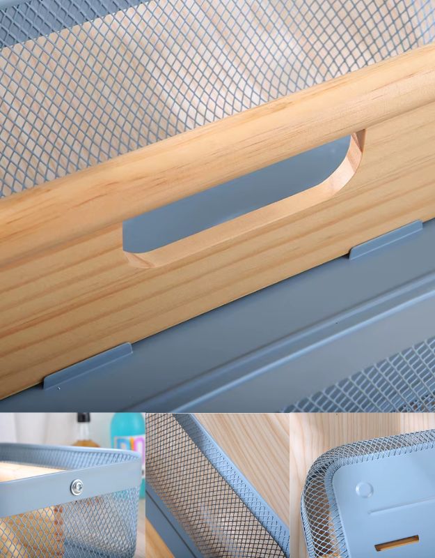 Close-up of fruit storage basket showing wooden handle and durable metal mesh design.