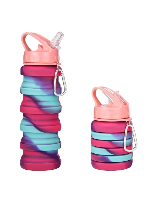 Collapsible pink and teal Genie water bottle shown side by side in expanded and collapsed forms, with coral pink lid and carabiner