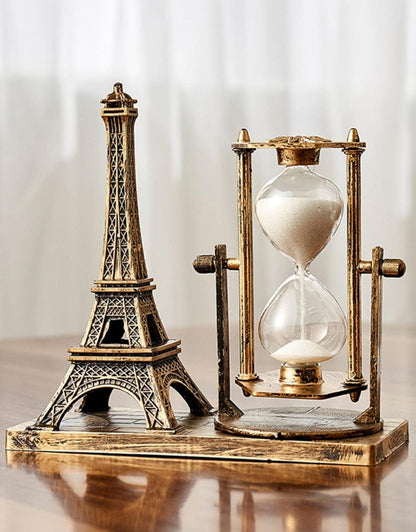 Gold Eiffel Tower with Hourglass Timer on Wooden Base – Close-up on Wooden Table