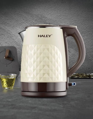 Haley 2.2L double-layer electric kettle displayed on a modern kitchen counter beside a cup of tea